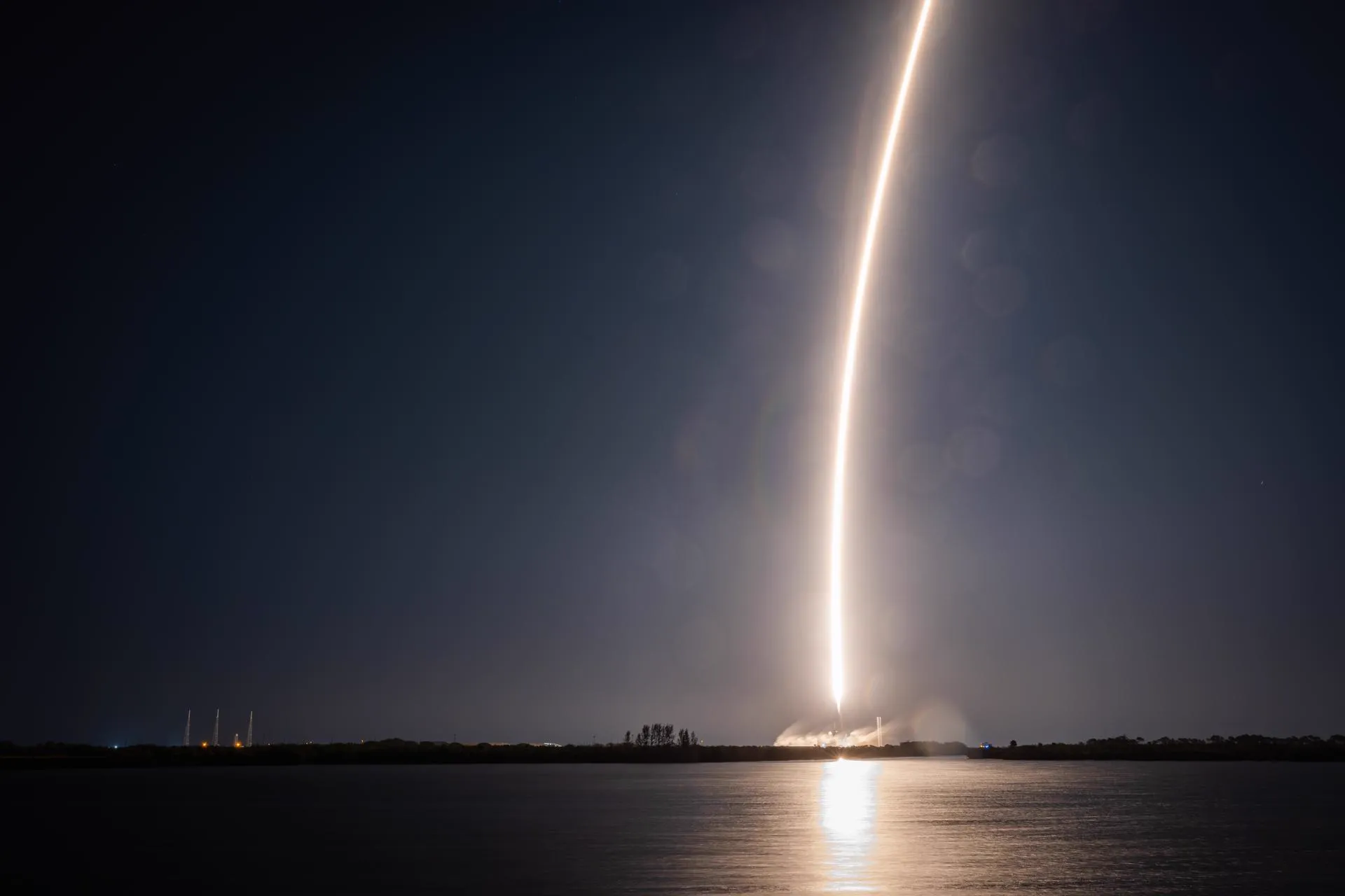 Rocket launch drawing a streak of light across the night sky